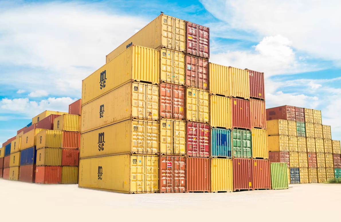 Stacked shipping containers at a port, representing cargo waiting for an importer of record in Rwanda